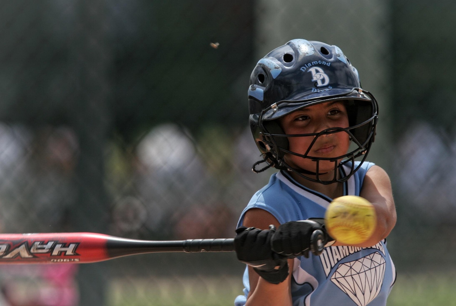 Youth softball players developing skills during a coached practice