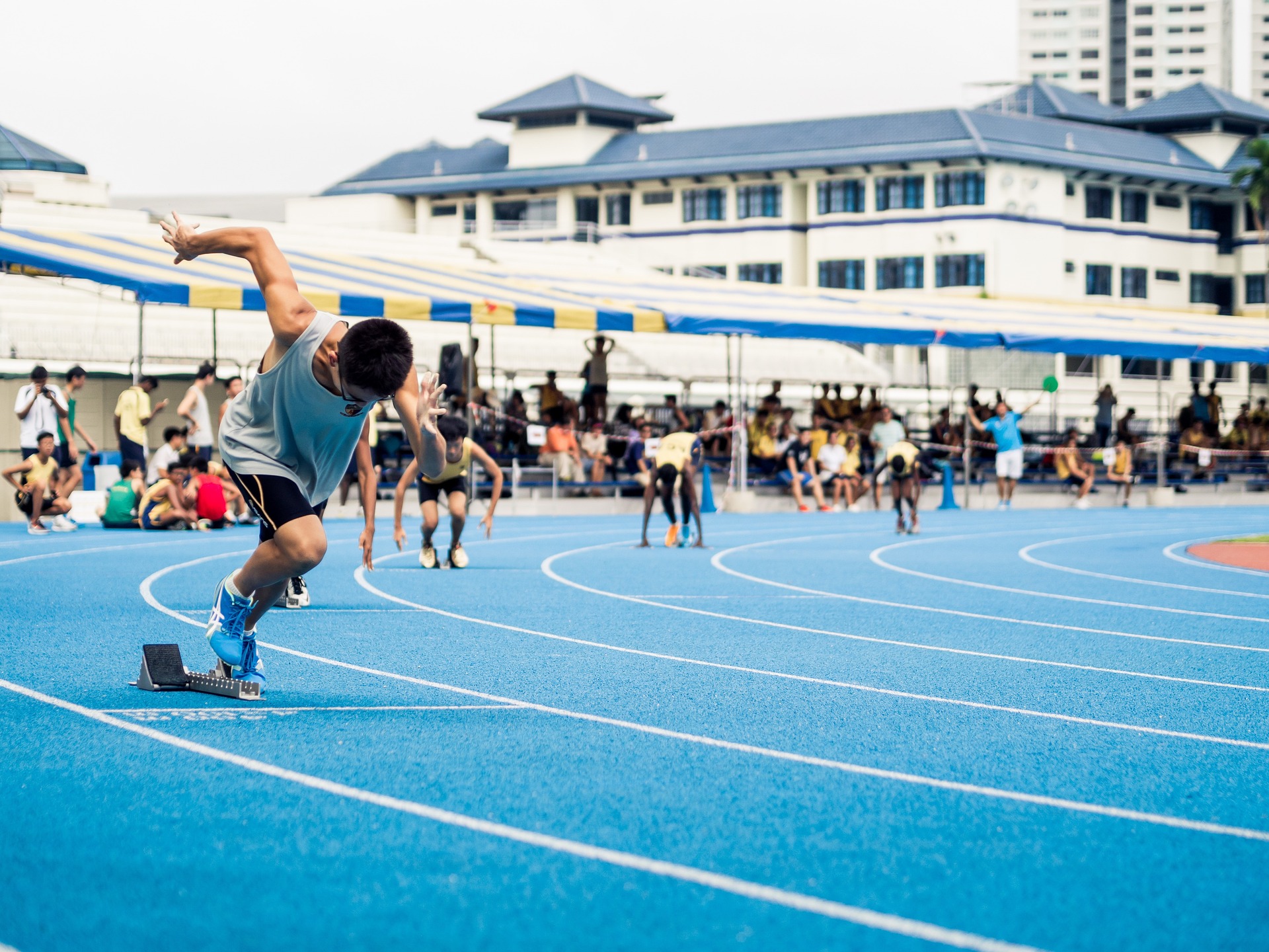 Track & Field youth athletes practicing with coach guidance